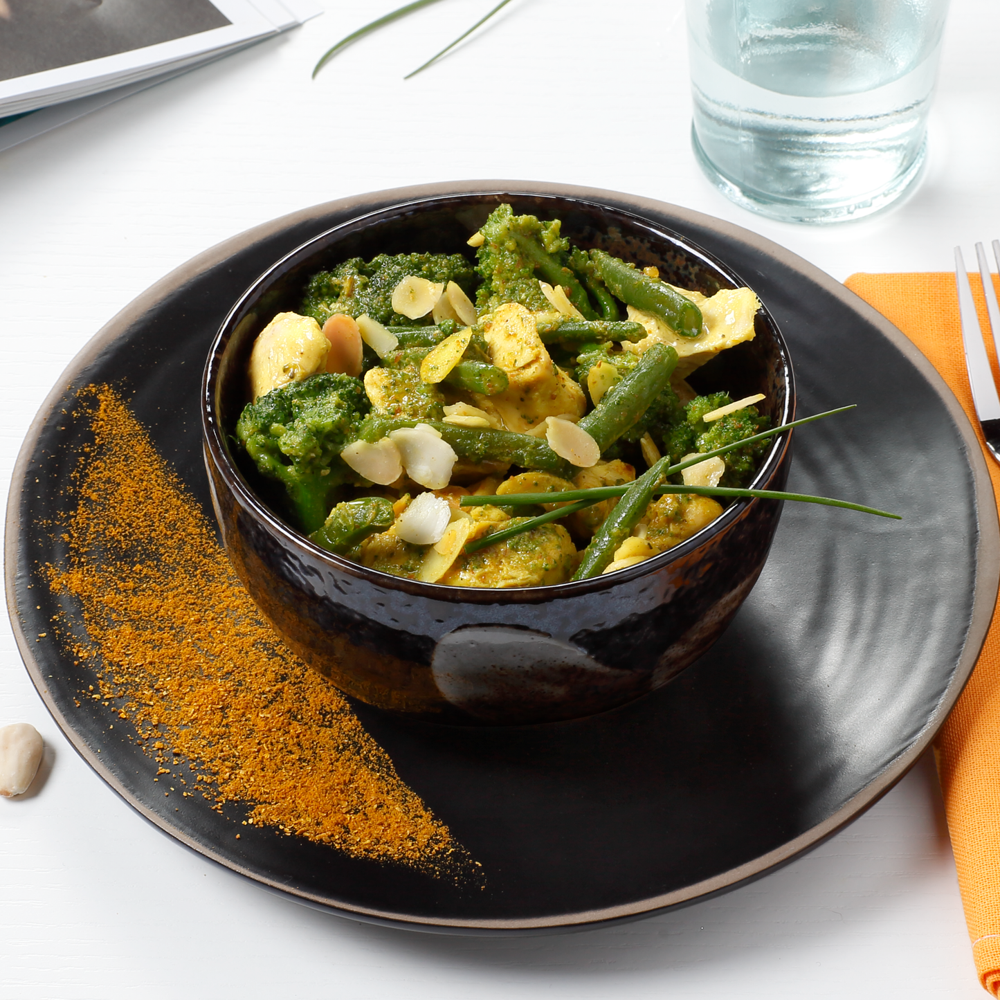 Bocconcini di pollo al curry, broccoli, fagiolini e mandorle